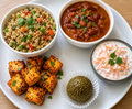 Quinoa pulao, rajma gravy curry with paneer fry, carrot raita and moringa ladoo